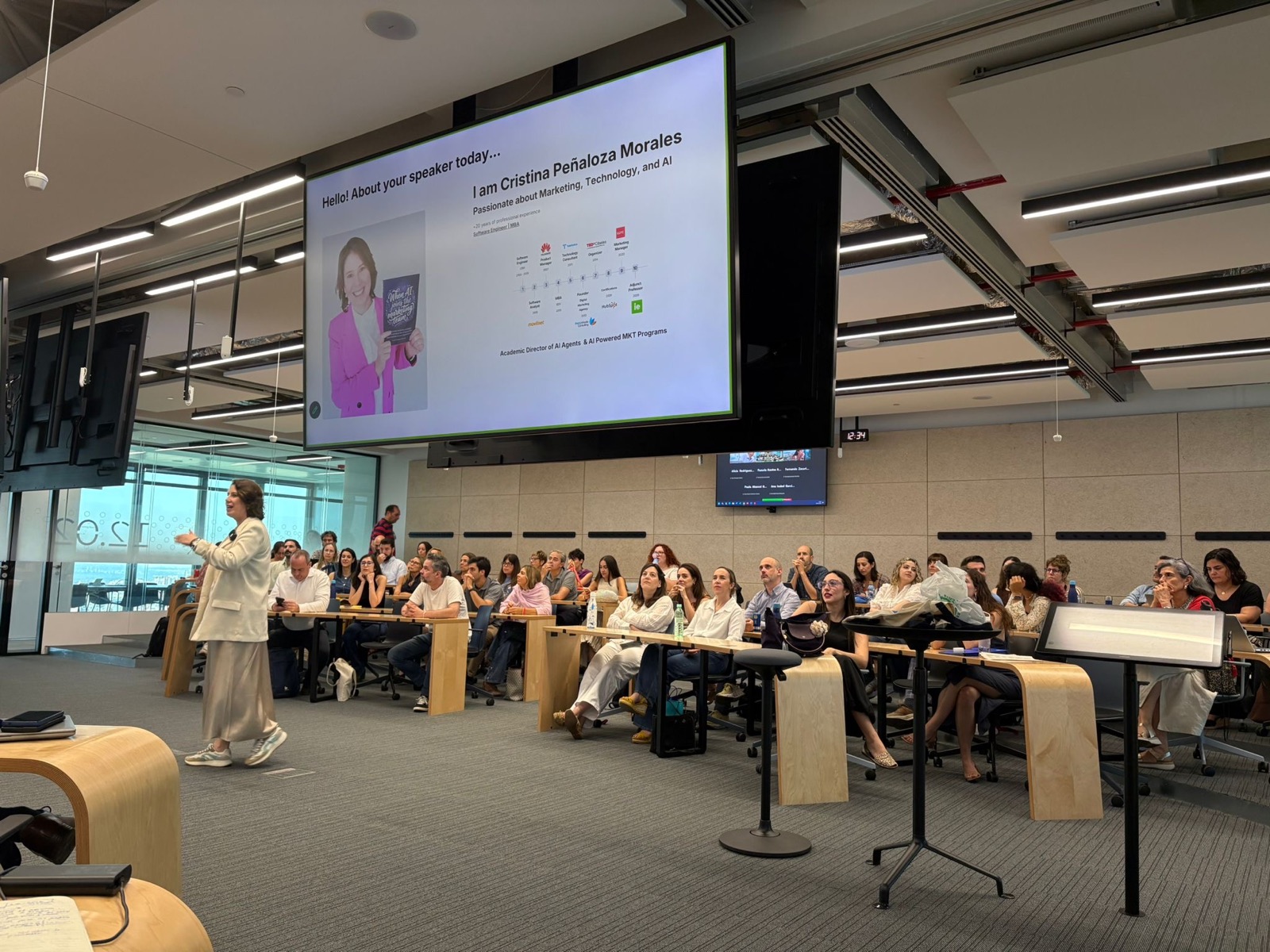 Cristina presenting to a full executive classroom at IE